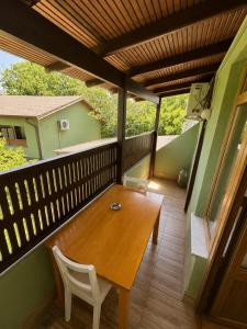 a porch with a wooden table and chairs on a balcony at Motto Polonezköy in Beykoz