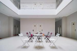 a dining room with a table and chairs at Urbanview Hotel Bari Syariah Palembang By RedDoorz in Sukarami