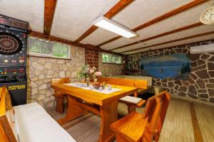 a dining room with a table and a stone wall at Villa Adry 2 in Bribir