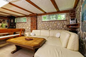 a living room with a white couch and a table at Villa Adry 2 in Bribir
