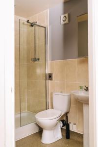 a bathroom with a toilet and a shower and a sink at Red Lion Inn and Motel in York