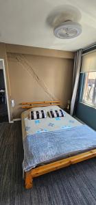 a bedroom with a bed with a blue comforter at Le petit Rouen in Rouen