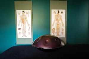 a bowl sitting on a table next to two posters at Chambre d'hôtes Ahetzina in Ahetze