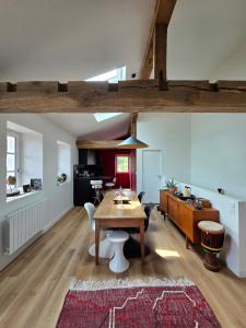 a living room with a table and a dining room at Chambre d'hôtes Ahetzina in Ahetze