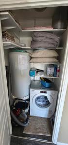 a small refrigerator with a washing machine in it at Le petit Rouen in Rouen +3 photos