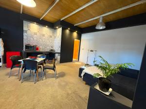 a bedroom with a bed and a table and chairs at Alto Valle Lofst in San Fernando del Valle de Catamarca