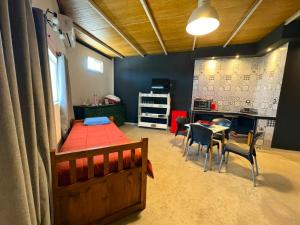 a bedroom with a bed and a table and chairs at Alto Valle Lofst in San Fernando del Valle de Catamarca