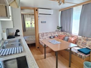 a kitchen and living room with a couch and a table at Lexi Zen House in Kamnik +22 photos