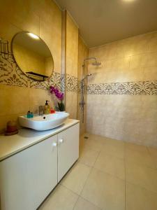 a bathroom with a sink and a mirror and a shower at New House Kobuleti 2 in Kobuleti +66 photos