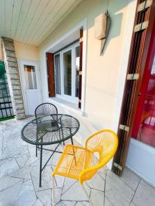 a table and two chairs on a patio at Zen & uS Maison entière in Margny-lès-Compiègne