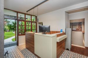 a home office with a tv and a desk at Hotel Hanioti Village Spa in Hanioti