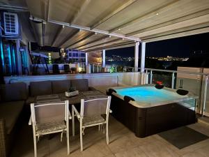 a balcony with a hot tub and a table and chairs at YS Residence in Sunny Beach