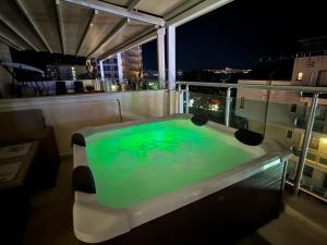 a swimming pool on the roof of a building at night at YS Residence in Sunny Beach