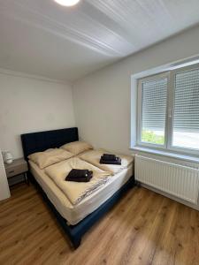 a bedroom with a bed with two bags on it at Bodenseeapartments in Friedrichshafen