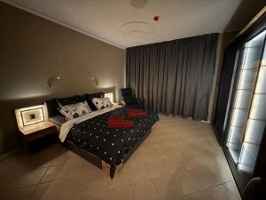 a bedroom with a bed and a large window at YS Residence in Sunny Beach