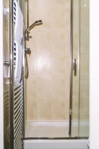 a bathroom with a shower with a glass door at Red Lion Inn and Motel in York