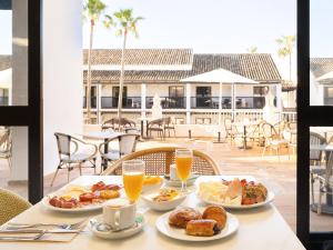 a table with three plates of breakfast food on it at Ona Diana Park in Estepona