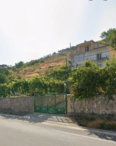 a gate in front of a house on a hill at Alira Rooms in Pogradec