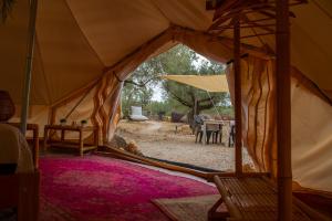 a large tent with a table and chairs in it at Paraiso Bell Tent - Glamping with Pool in Nature in Tortosa