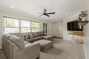a living room with a couch and a flat screen tv at New! Cozy Family Getaway: Amish Farmland|Patio|Washer & Dryer|Central Lancaster County in Ronks