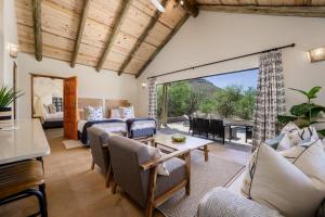 a living room with a couch and a table at Glen Harry Game Reserve in Graaff-Reinet