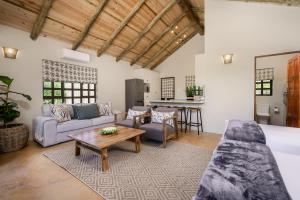 a living room with a couch and a table at Glen Harry Game Reserve in Graaff-Reinet