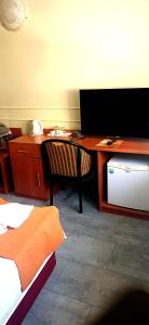 a room with a desk with a computer and a chair at Atlantic Hotel in Budapest