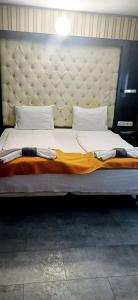 a large bed with a large headboard in a room at Atlantic Hotel in Budapest