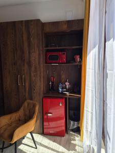 a red cabinet with a red drawer and a red microwave at WILLA VASCO BOSMAN in Rewa