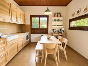 a kitchen with a table and chairs in it at The Cottage in the Trees in Tsagarada
