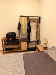 a bedroom with a closet and a bed and a table at Résidence Leyla in Abidjan