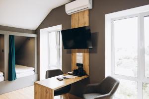 a room with a desk and two chairs and a bed at Полінарія Козятин in Kozyatyn