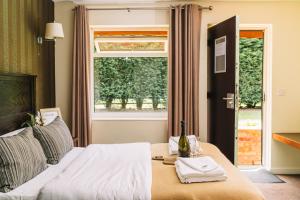 a bedroom with a bed with a window and a table at Red Lion Inn and Motel in York