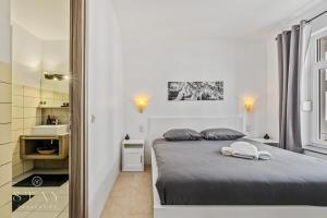 a bedroom with a bed with two towels on it at Hotel Stay Properties in Luxembourg