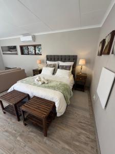a bedroom with a large bed with a dog laying on it at Olive Branch Cottage off grid in Benoni +28 photos