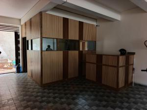 a room with wooden cabinets and a person in the mirror at hotelnishainn in Rānchī