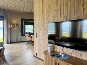 a living room with a large flat screen tv at Flakstad beach house Silo A in Vareid