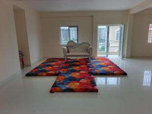 a room with a rug on the floor with a couch at hotelnishainn in Rānchī +1 photo