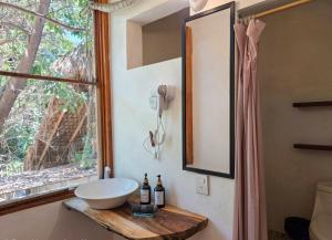 a bathroom with a bowl sink and a window at Zipolite Maracuya Hostel & Rooms in Zipolite +58 photos