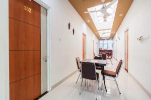 a conference room with a table and chairs at RedDoorz Plus near Palembang Airport 3 in Palembang