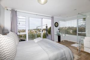 a bedroom with a bed and a large window at Alfred View in Port Alfred