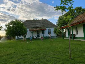a group of people playing soccer in a yard at Konyhadűlő Vendégház in Kiskunmajsa