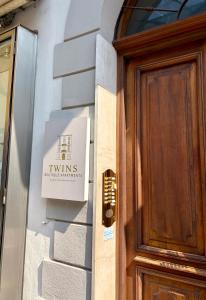 a sign on the side of a building next to a door at Twins Boutique Apartments in Sanremo