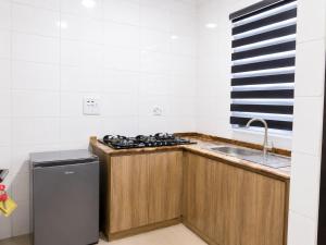 a kitchen with a stove and a sink at Aaron Obibi Court in Owerri