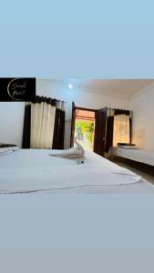 a large bed in a room with a window at Saiesh resort in Alibaug