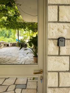a door to a patio with a potted plant at Cozy house Luana in Lopud