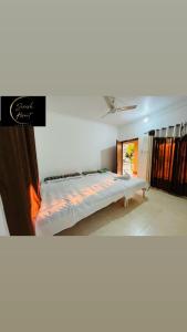 a bedroom with a large bed in a room at Saiesh resort in Alibaug