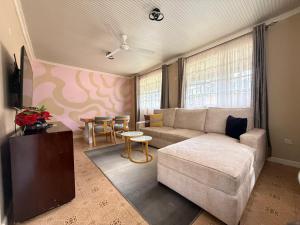 a living room with a couch and a table at MILIMANI DRIVE LIVINGs in Kisumu