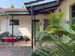 a house with a green door and some plants at MILIMANI DRIVE LIVINGs in Kisumu
