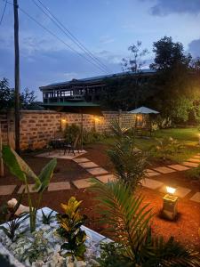 a garden with a building in the background at MILIMANI DRIVE LIVINGs in Kisumu